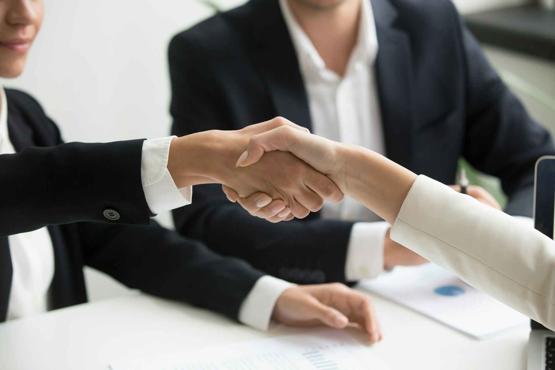 Bankers shaking hands with a loan applicant