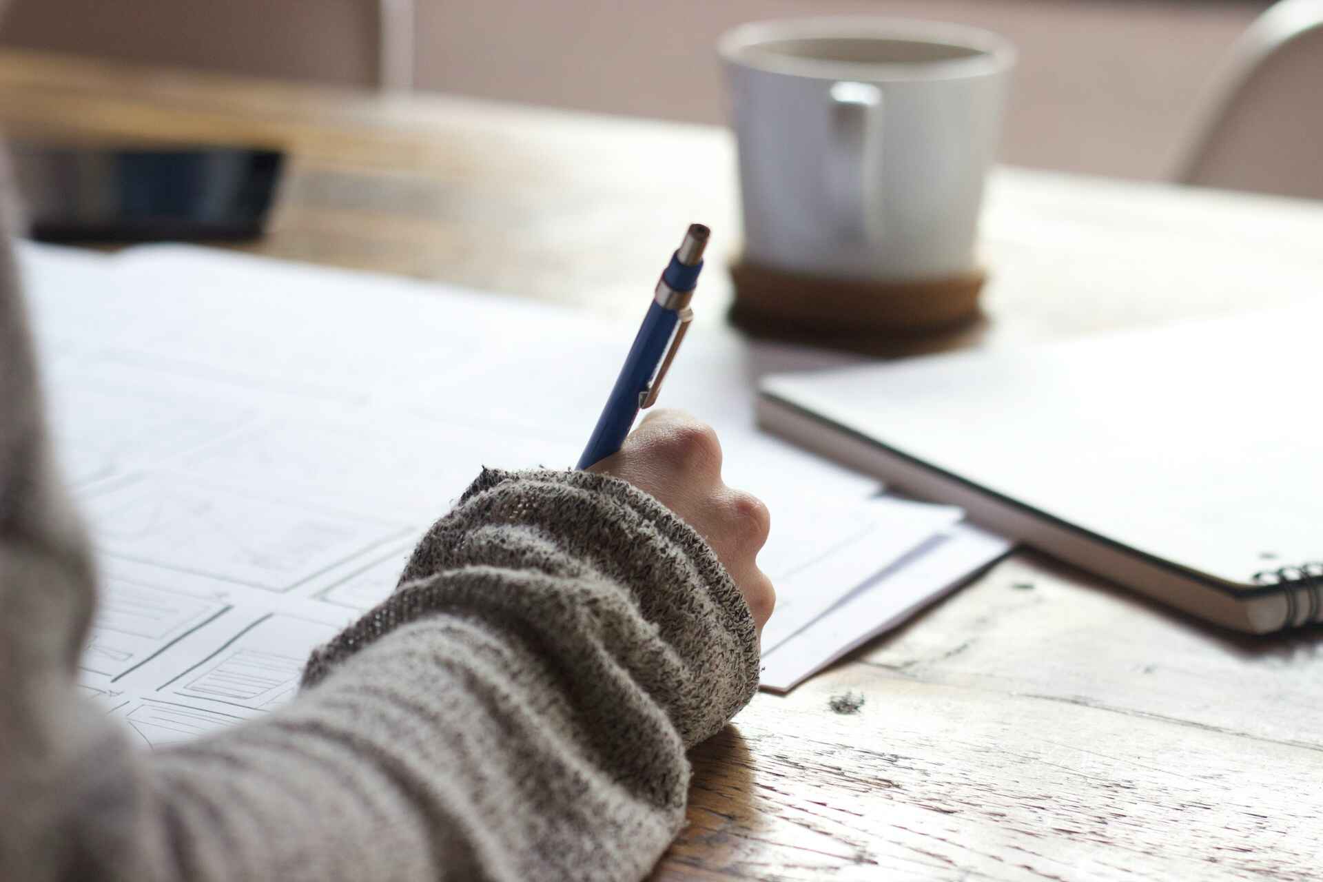 Person writing on a piece of paper