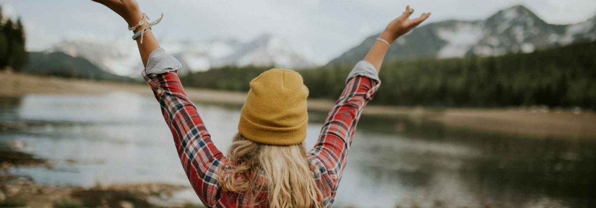 Woman with her arms outstretched outdoors