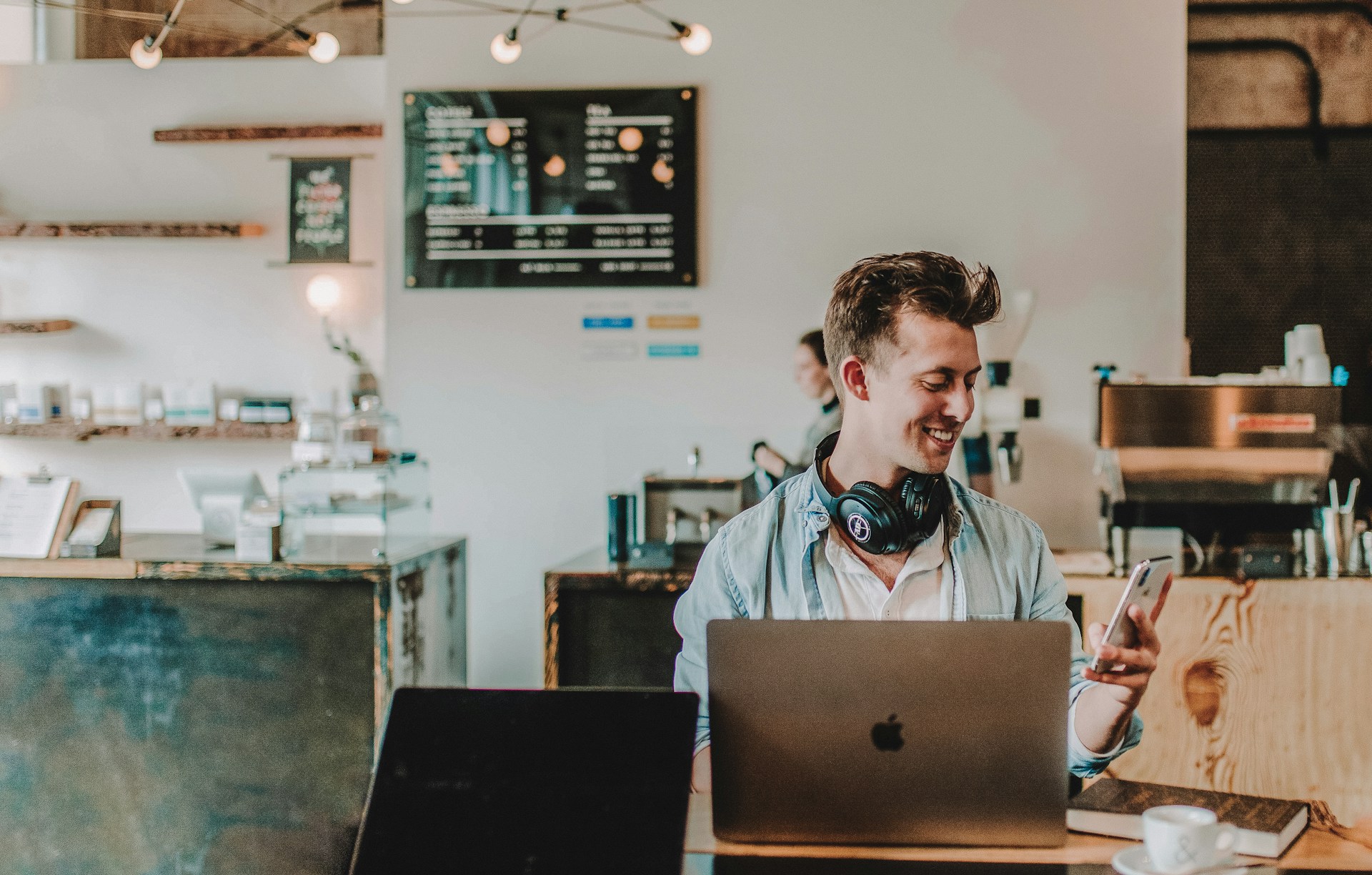 Man smiling as he reviews a consolidation loan approval on his smartphone